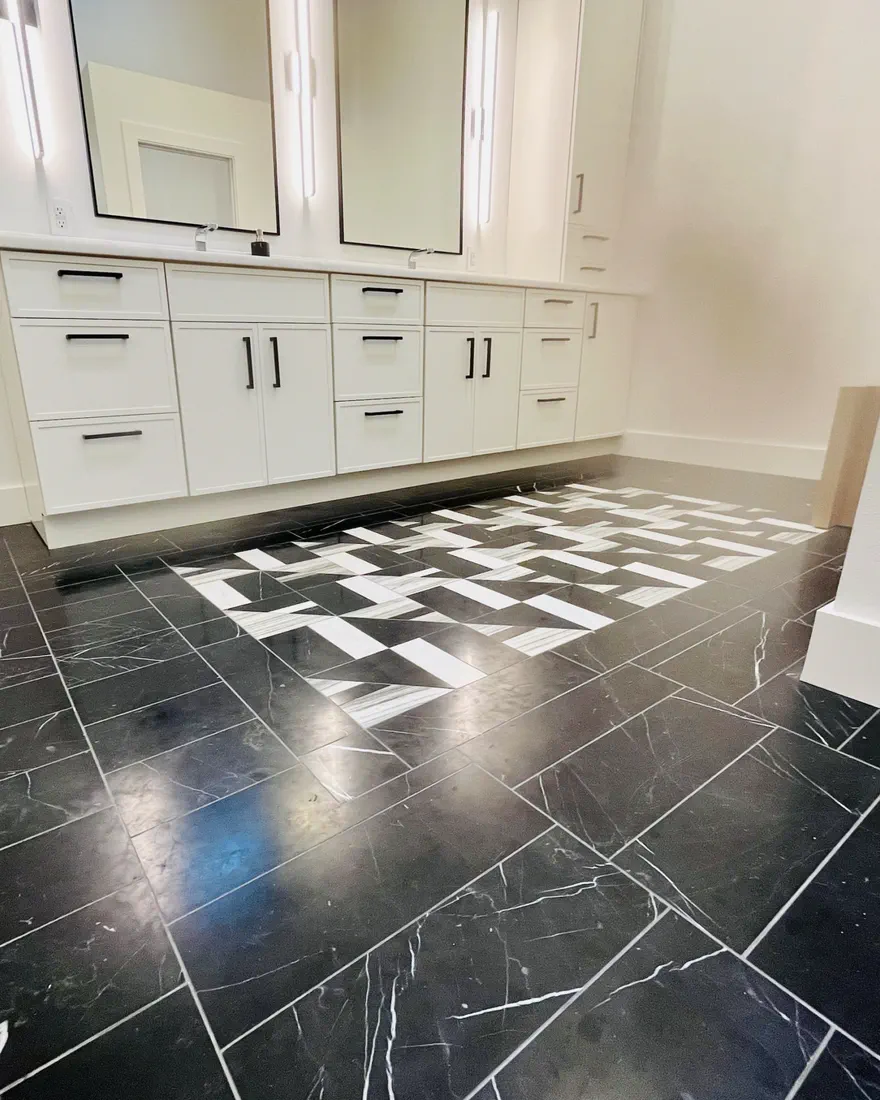 Epoxy-grouted black floor with a patterned inlay