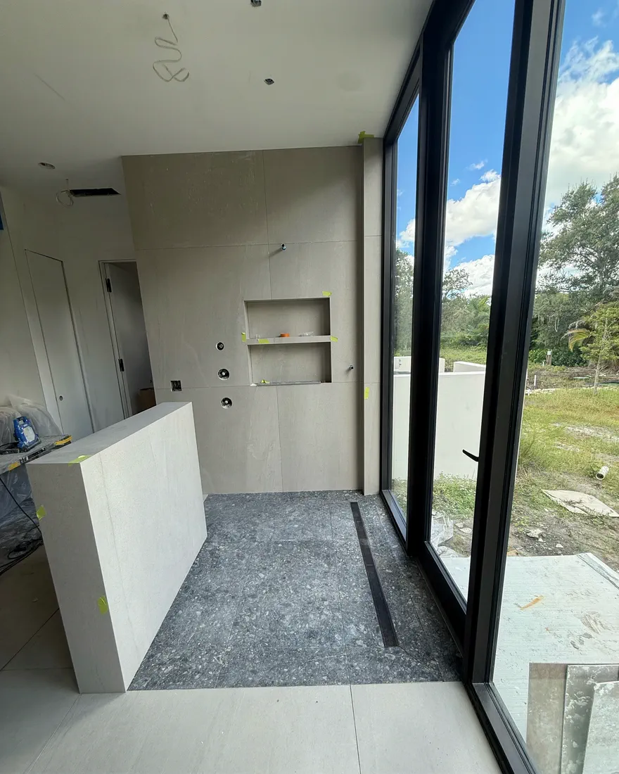 Shower under construction with a double niche built into the tiled wall