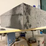 Mitered lava stone corner with a crisp seam, installed by Floors of Glory